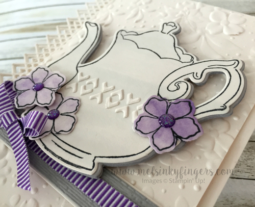 An ink wash, pieces from the Delicate Lace edgelit dies, and the flowers from the Tea Time die set add perfect details.